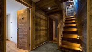 A wooden interior with a staircase leading to an upper level.