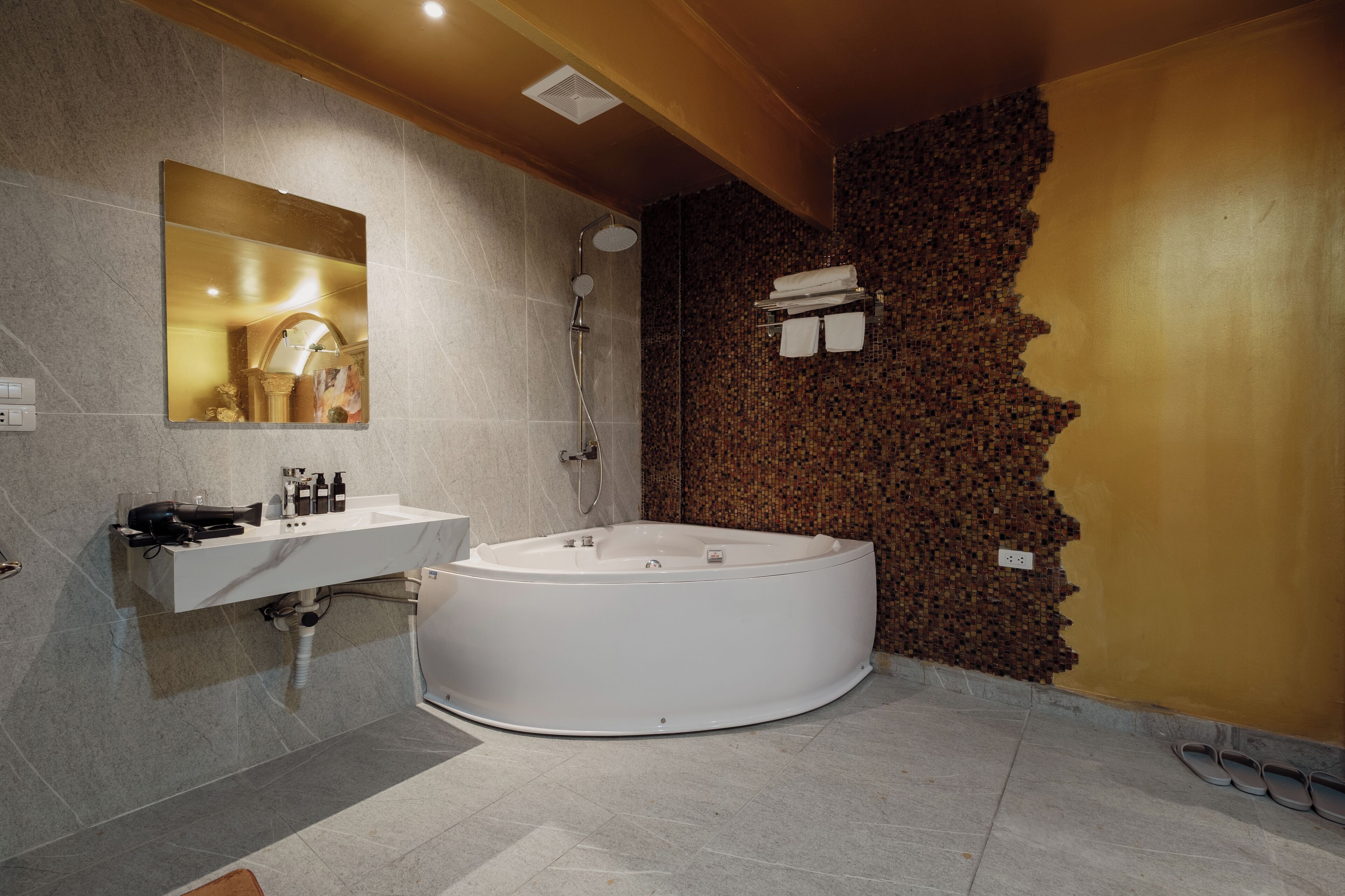 A modern bathroom with a large bathtub, a sink, and a shower.