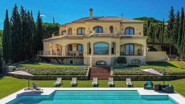 A large, two-story house with a swimming pool in front. - 8 bedroom luxury villa + sea, golf course and mountain views (Sotogrande)