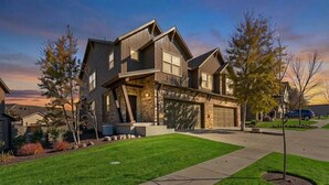 A modern two-story house with a stone facade, a garage, and a well-maintained lawn. - Aspen Crest Condo, 4BR, Deer Valley, hot tub (Kamas)