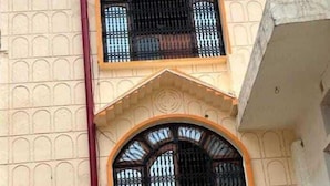A building with a sign reading "AYODHYA CANTT PALACE & RESTAURANT AC & AC ROOMS".