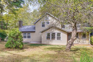 A two-story house with a chimney, a tree in front, and a bicycle parked outside. - Pet-Friendly Ski, Swim & Relax Poconos Getaway (Pocono Pines)