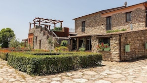 A stone building with a covered outdoor area and a stone pathway.