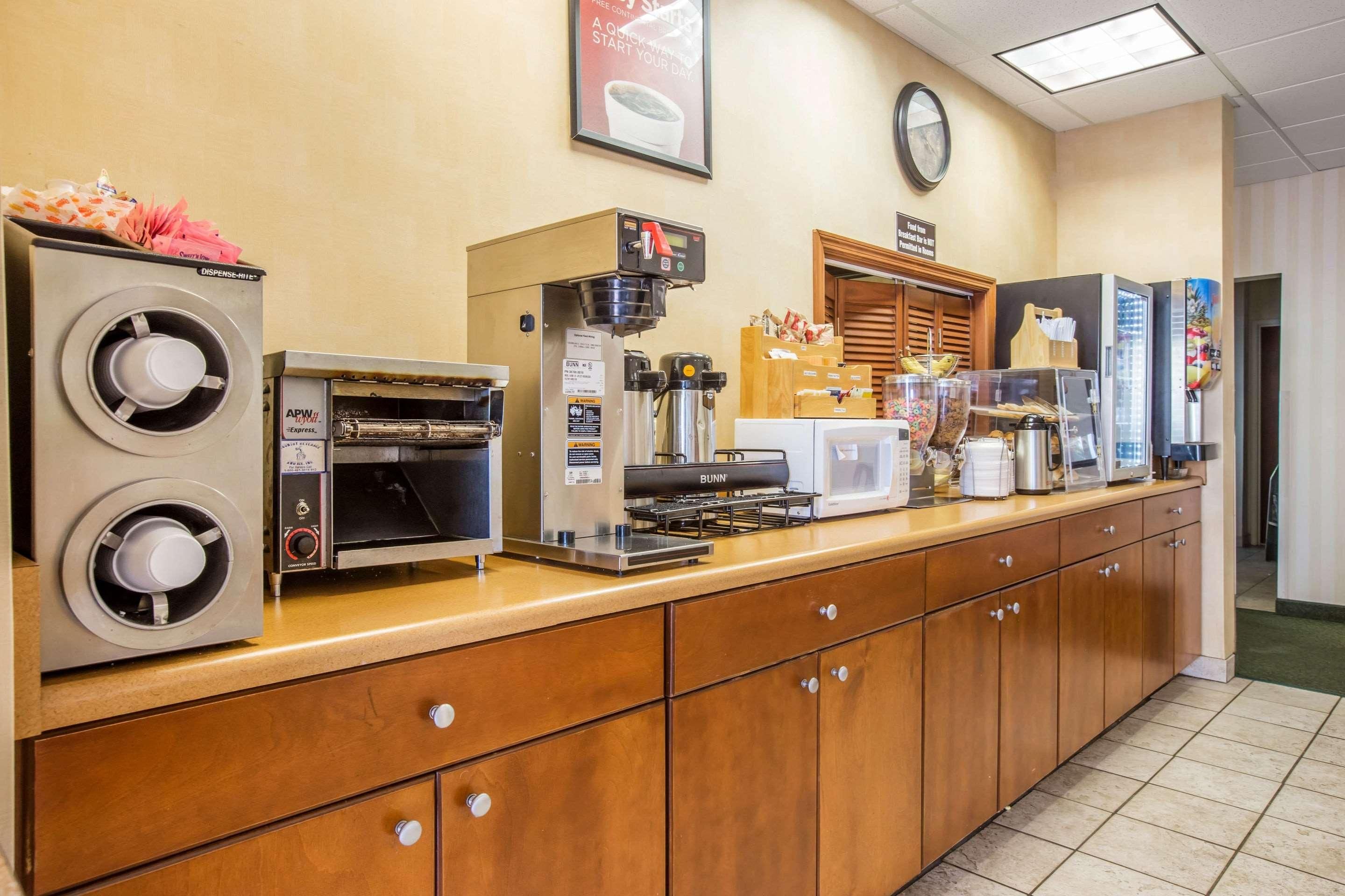 Un espace où l'on peut se servir soi-même pour le petit-déjeuner, avec des machines à café, un four à micro-ondes et une variété d'aliments.