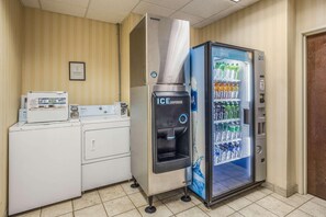 A hotel room with a refrigerator, a microwave, and a water dispenser. - Econo Lodge Valdosta (Valdosta)