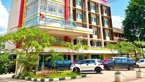 A multi-story hotel with a distinctive facade featuring intricate patterns and a prominent red and yellow color scheme. - SERRA HOTEL BATAM (Batam)
