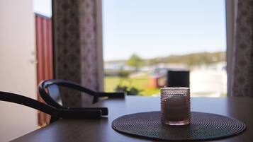 A table with a textured placemat and a glass of water. A chair is partially visible to the left.