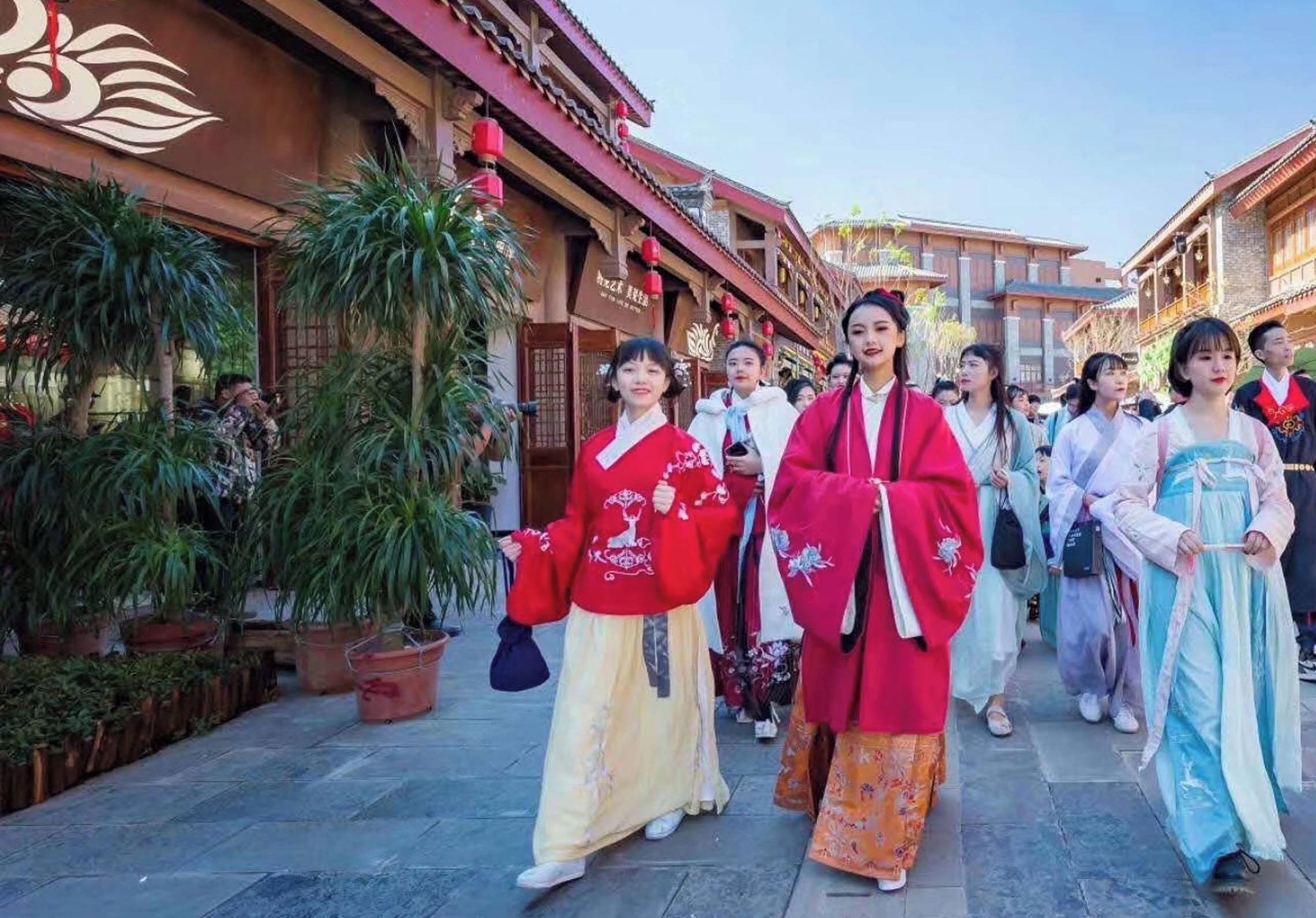 A traditional Chinese street with people in traditional attire.