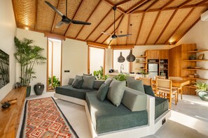 Deluxe Villa, Patio, Pool View | Living room | 50-inch flat-screen TV with cable channels