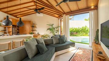 Deluxe Villa, Patio, Pool View | Living area