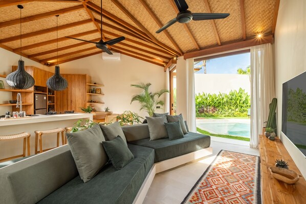 Deluxe Villa, Patio, Pool View | Living area