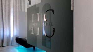 Un interior moderno con un panel de vidrio que muestra los textos 'KEY SUITE' y 'HOUSE'.