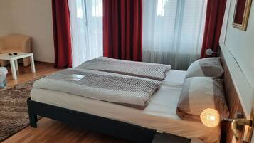 A bedroom with a bed, bedside table, and a lamp.
