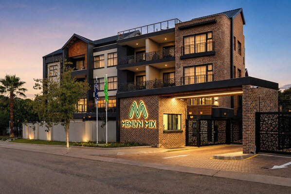 A multi-story hotel with a prominent 'Menlyn Mix' sign, balconies, and a brick facade. - Menlyn Mix (Pretoria)