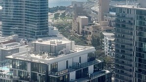 A high-rise building with a modern architectural design, featuring a mix of glass and concrete facades. - Beautiful Two-Bedroom Escape Ocean & City Views from Every Room (San Diego)