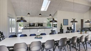 A modern kitchen with white cabinets, a central island, and pendant lighting. - VillaVilla 419 - Blåvand, Vestjylland (Blåvand)