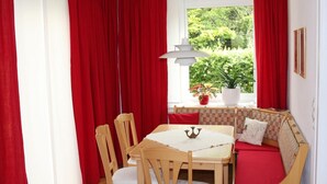 A dining area with a table, chairs, and a bench.