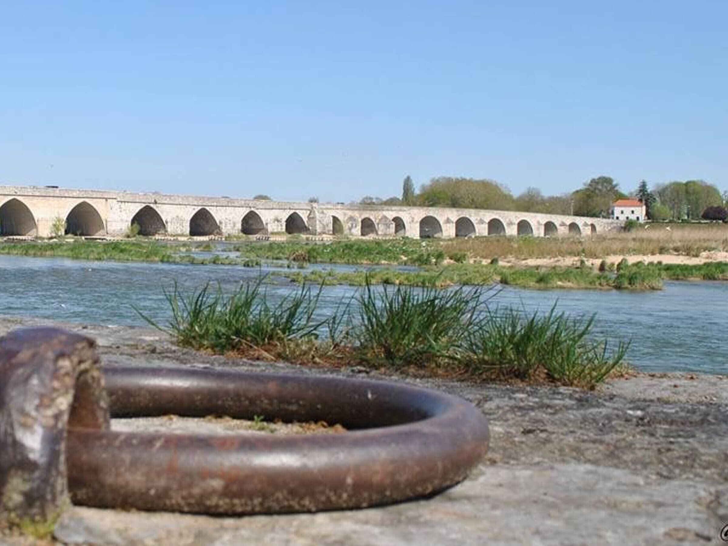 A bridge with multiple arches over a river.