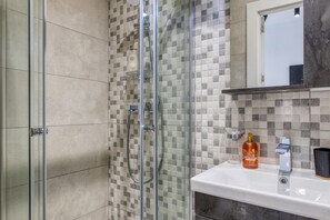 Shower, hair dryer, towels, toilet paper