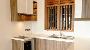 A kitchen with a built-in dishwasher, a sink, and wooden cabinetry.