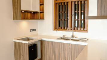 A kitchen with a built-in dishwasher, a sink, and wooden cabinetry.