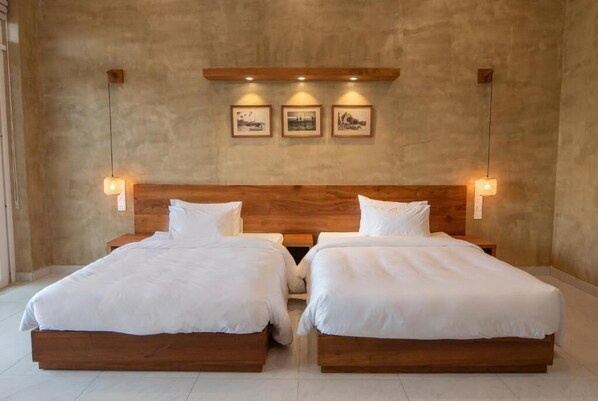 A double room with two beds, wooden headboard, and wall-mounted lights. - At Kelly's Ambalangoda (Ambalangoda)