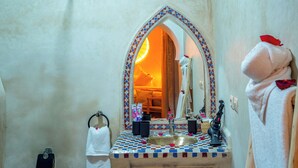 A bathroom with a checkered tile sink, a mirror, and a towel rack. - Riad le Graff Pink (Marrakech)