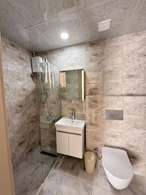 Standard Triple Room, Balcony | Bathroom | Shower, hair dryer, slippers, towels