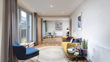 Penthouse Two Bedroom Apartment | Living area | 40-inch Smart TV with satellite channels