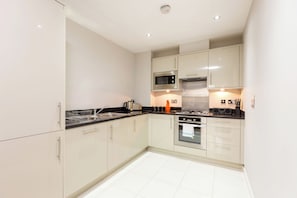 Two Bedroom Apartment | Private kitchen | Full-size fridge, microwave, oven, stovetop