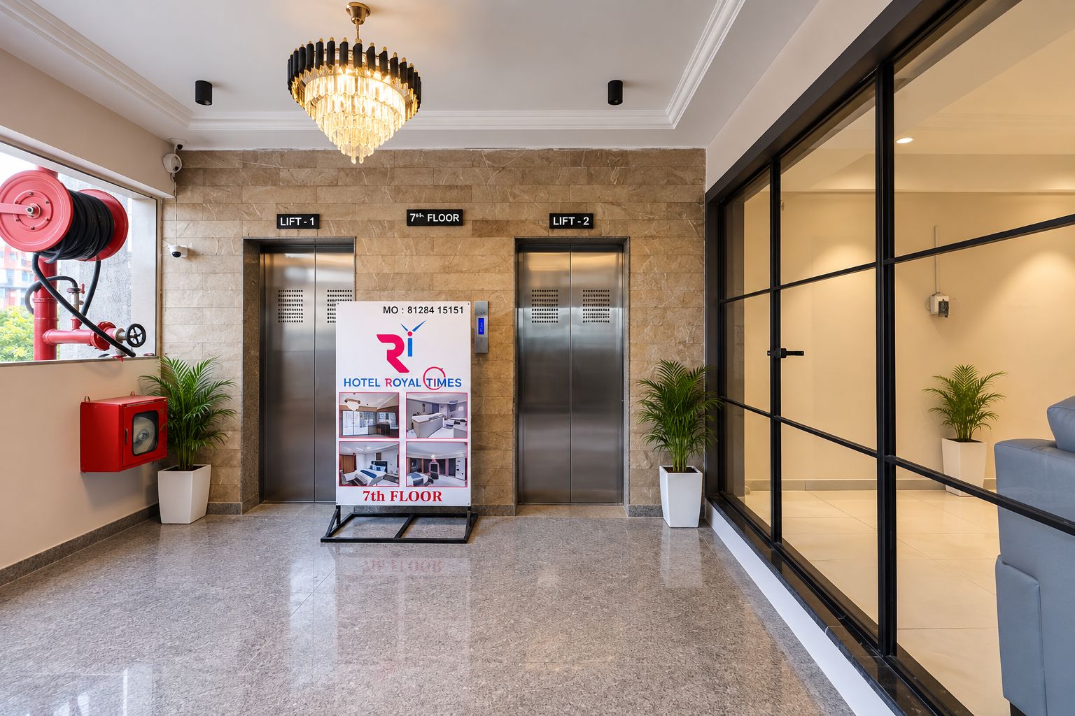 A hotel lobby with two elevators, a chandelier, and a sign for the 7th floor.
