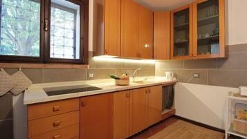 Apartment, Patio, Garden View | Private kitchen | Fridge, espresso maker, high chair, cookware/dishes/utensils