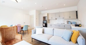 A modern living room with a sofa, chairs, and a dining area. - Modern 3BD Split-Level Home with Balcony,Dublin 16 (Dublin)