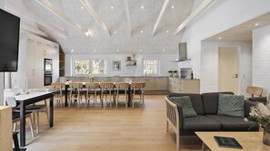 A spacious living area with a dining table, chairs, a sofa, and a TV. - VillaVilla 145 - Vester Husby, Vestjylland (Ulfborg)