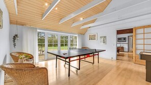 A room with a ping pong table, wicker furniture, and large windows. - VillaVilla 145 - Vester Husby, Vestjylland (Ulfborg)