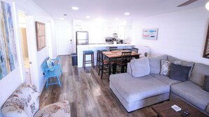 A compact living space with a dining area, kitchenette, and a gray sofa. - Bayview Freedom (Orange Beach)
