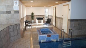 An indoor swimming pool area with a small hot tub, a table with chairs, and a foosball table. - VillaVilla 78 - Öland, Sverige (Köpingsvik)