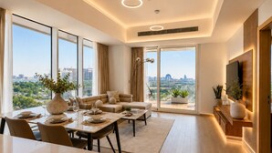 Un salon moderne avec un coin repas, de grandes fenêtres et une vue sur la ville.
