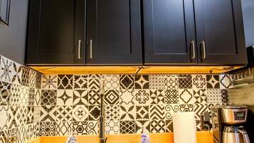 Fridge, microwave, coffee/tea maker, cookware/dishes/utensils