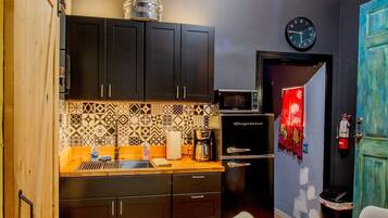 Fridge, microwave, coffee/tea maker, cookware/dishes/utensils