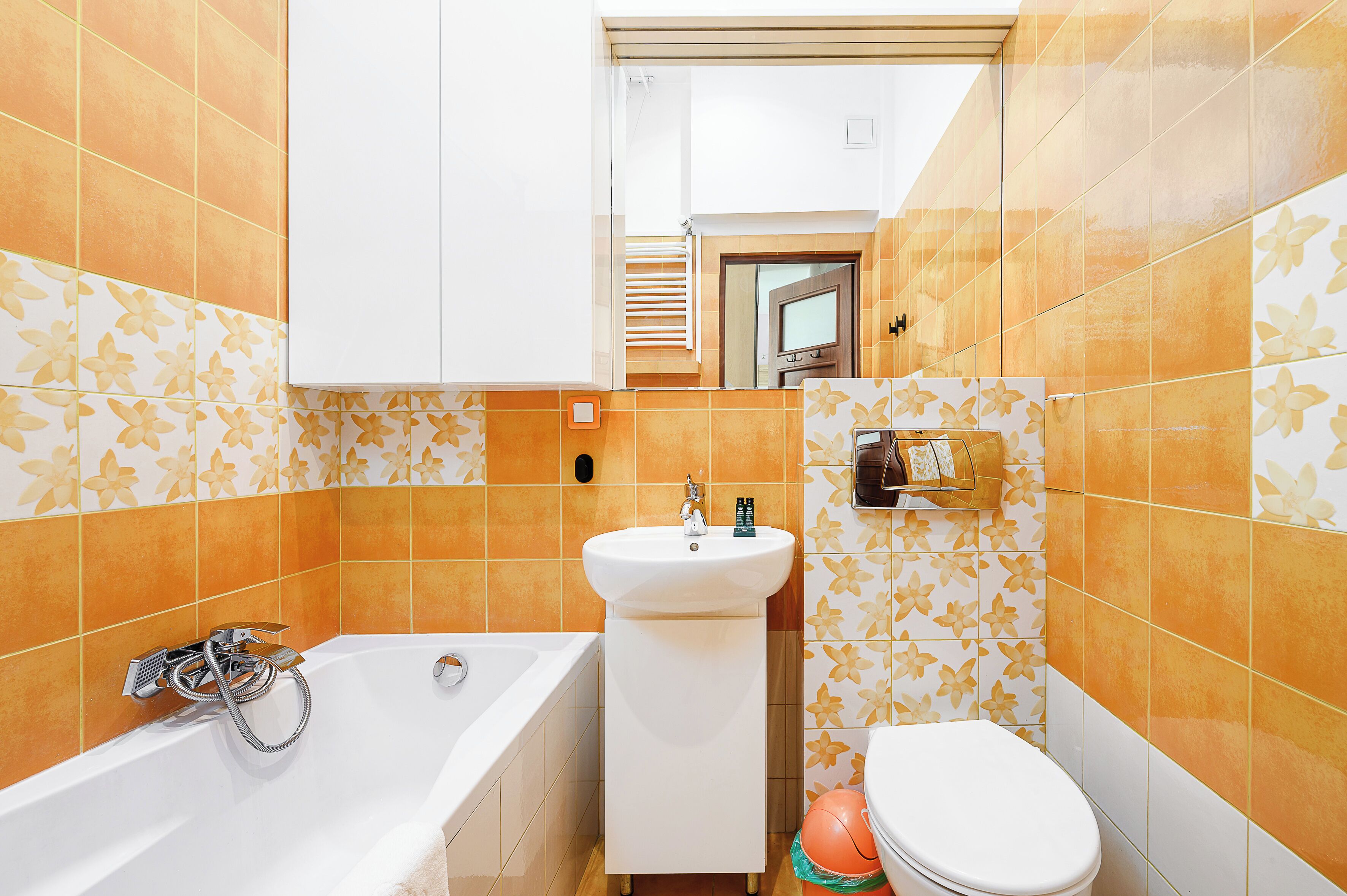 A bathroom with a bathtub, a sink, and a toilet.
