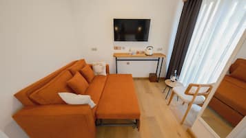 Deluxe Room, City View | Living area | 42-inch Smart TV with cable channels