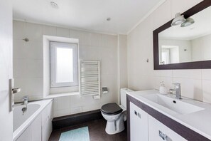 A modern bathroom with a bathtub, toilet, and sink. - Superb accommodation close to station and freeway (Savigny-sur-Orge)
