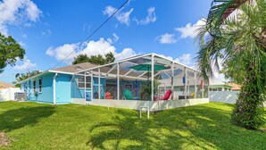 A house with a covered porch and a lawn. - Fenced Yard, Game Room: Family Home in Sebastian! (Sebastian)