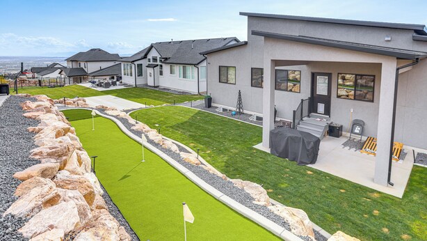 A modern residential area with houses, a well-maintained lawn, and a golf course. - Pool Table & Putting Green! Scenic Ogden Escape (Ogden)