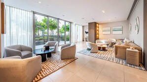 A modern living room with a sofa set, a coffee table, and a dining area. - Iconic Burj Khalifa & Fountain Views, 2BR Downtown (Dubai)