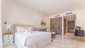 A modern hotel room with a large bed, bedside tables, a desk, and a chair. - Furnished Studio with Burj Khalifa View, Near Dubai Water Canal (Dubai)