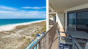 A balcony with a view of a beach and a pool. - Phoenix Vi 61113 3 Bedroom Condo (Orange Beach)