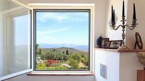 A room with a large window overlooking a landscape with mountains and greenery. - Chirchiaro - Four Bedroom Villa, Sleeps 8 (Salemi)