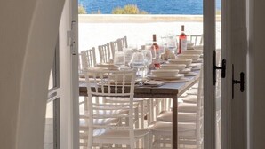 A dining area with a table set for six, overlooking the sea. - Blu Melia - Seven Bedroom Villa, Sleeps 14 (Contrada Guardiola)